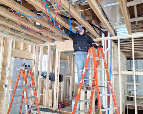 Man On Ladder Checking Plumbing